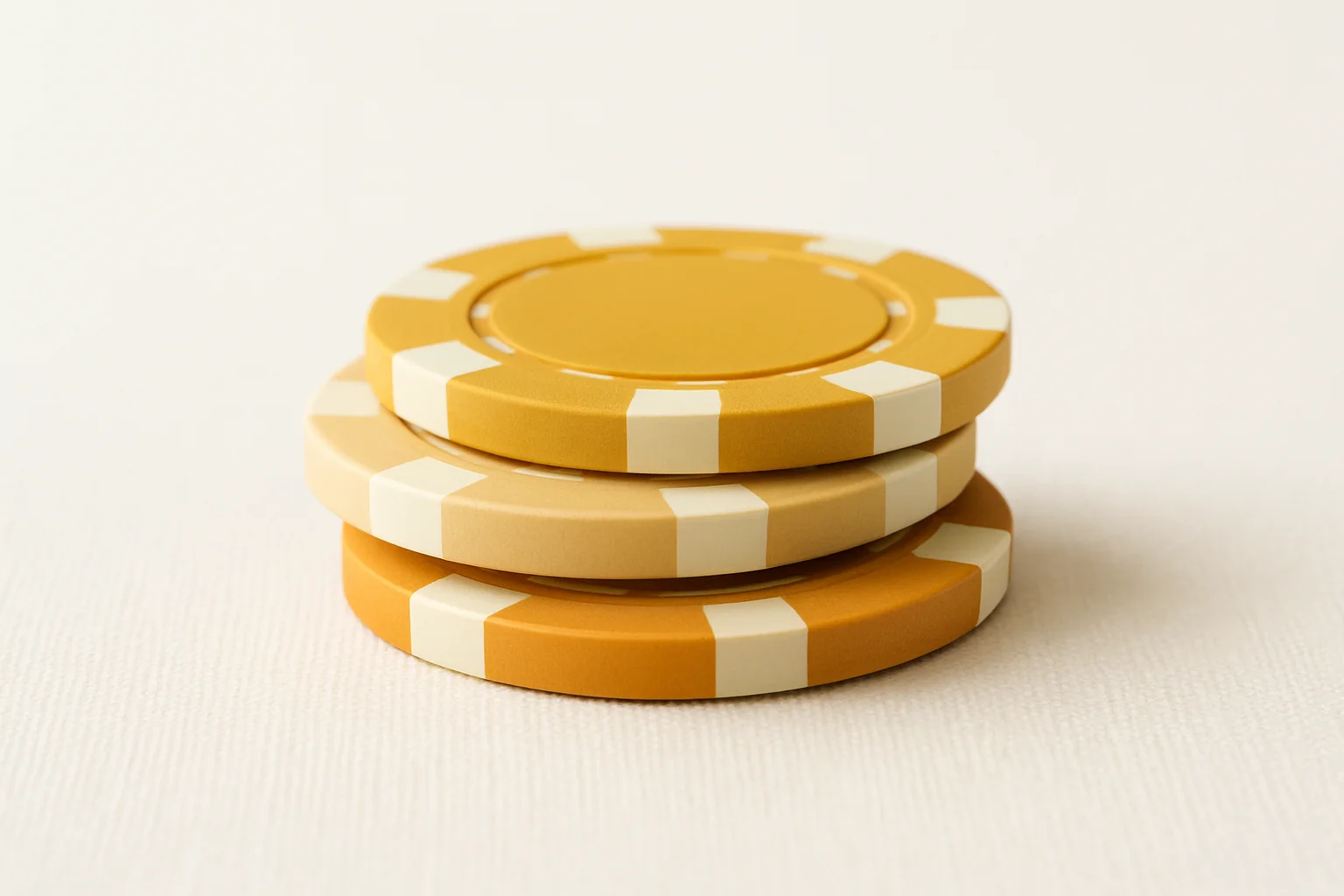 Three stacked poker chip denominations on white background with subtle shadows